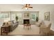 Bright living room featuring a fireplace, large windows, and comfortable seating at 3731 Laramie Rd, Ellenwood, GA 30294