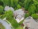 Aerial view of a luxury home nestled among lush trees with a large deck at 5705 Registry Oaks Se Ln, Mableton, GA 30126