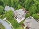 Aerial view of a home showcasing its well-manicured lawn, driveway, and surrounding mature trees at 5705 Registry Oaks Se Ln, Mableton, GA 30126