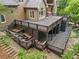 Multi-level stained wood deck features railings, stairs, an enclosed space, and a playful nook at 5705 Registry Oaks Se Ln, Mableton, GA 30126