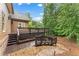 Multi-level stained wood deck with railings, steps, and planter boxes overlooks a wooded yard at 5705 Registry Oaks Se Ln, Mableton, GA 30126