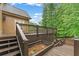 Multi-level stained wood deck with railings and stairs overlooking a wooded yard at 5705 Registry Oaks Se Ln, Mableton, GA 30126