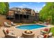 Backyard pool and patio featuring a fire pit, lounge chairs, and mature trees at 5705 Registry Oaks Se Ln, Mableton, GA 30126