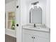 Bathroom with a stylish arched mirror, modern vanity, and ample lighting at 5705 Registry Oaks Se Ln, Mableton, GA 30126