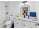 Bright bathroom features white cabinets, a modern sink, and a decorative mirror creating an airy and pleasant space at 5705 Registry Oaks Se Ln, Mableton, GA 30126