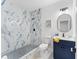 Modern bathroom with blue tiled shower, a white toilet, and a vanity with sink adding luxury to the home at 5705 Registry Oaks Se Ln, Mableton, GA 30126