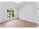Bedroom with light wood floors, a large window, and white walls at 5705 Registry Oaks Se Ln, Mableton, GA 30126