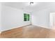 Bright bedroom featuring a large window and hardwood flooring at 5705 Registry Oaks Se Ln, Mableton, GA 30126