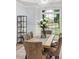 Dining room with a rectangular wood table, upholstered chairs, a modern chandelier and a large window at 5705 Registry Oaks Se Ln, Mableton, GA 30126