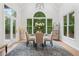 Sun-lit dining room with large windows, offering views of the lush greenery, creating a peaceful ambiance at 5705 Registry Oaks Se Ln, Mableton, GA 30126