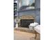 Close-up of a blue fireplace mantel with a brick firebox and a decorative vase with botanicals at 5705 Registry Oaks Se Ln, Mableton, GA 30126