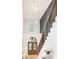 Elegant foyer with a decorative staircase, large chandelier, and stylish front door at 5705 Registry Oaks Se Ln, Mableton, GA 30126