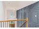 Elegant hallway featuring a spiral chandelier and decorative paneled wall at 5705 Registry Oaks Se Ln, Mableton, GA 30126