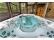 A close up shot of a hot tub with views to the pool house and nature at 5705 Registry Oaks Se Ln, Mableton, GA 30126