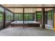 Screened-in porch featuring a large hot tub surrounded by lush greenery views at 5705 Registry Oaks Se Ln, Mableton, GA 30126