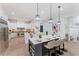 Modern kitchen with white cabinets, stainless steel appliances, and a large center island at 5705 Registry Oaks Se Ln, Mableton, GA 30126