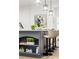 Chic kitchen island with counter seating, decorative lighting, and elegant decor at 5705 Registry Oaks Se Ln, Mableton, GA 30126