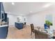 Eat-in kitchen features navy blue cabinets, marble countertops, and modern lighting at 5705 Registry Oaks Se Ln, Mableton, GA 30126