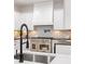 Well-equipped kitchen showcasing modern appliances, white cabinetry, and stylish backsplash at 5705 Registry Oaks Se Ln, Mableton, GA 30126