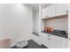 Functional laundry room featuring modern cabinetry, sleek countertops, and a convenient dog wash station at 5705 Registry Oaks Se Ln, Mableton, GA 30126