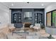Cozy living room showcases a blue built-in bookcase, brick fireplace, hardwood floors, and stylish furniture at 5705 Registry Oaks Se Ln, Mableton, GA 30126