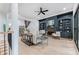 Open floor plan with a modern living room, dark blue built-ins, a stone fireplace, and hardwood floors at 5705 Registry Oaks Se Ln, Mableton, GA 30126