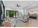 Bright living room featuring a fireplace, stylish furniture, and open access to the deck through folding doors at 5705 Registry Oaks Se Ln, Mableton, GA 30126