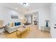 Bright living room featuring hardwood floors, a gray couch, and natural lighting creating an airy atmosphere at 5705 Registry Oaks Se Ln, Mableton, GA 30126