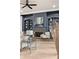 Bright living room featuring a stylish grey fireplace, a built-in bookcase, and hardwood floors at 5705 Registry Oaks Se Ln, Mableton, GA 30126