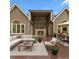Cozy outdoor patio with a fireplace, comfortable seating, and dining area for entertaining at 5705 Registry Oaks Se Ln, Mableton, GA 30126