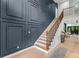 Stylish staircase with a wooden banister, leading to a bright, open living area at 5705 Registry Oaks Se Ln, Mableton, GA 30126