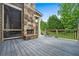 View of the spacious back deck, with a stone fireplace, railing, and steps leading to the yard at 771 Tate Overlook, Marietta, GA 30064