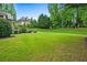 Sprawling backyard with lush green lawn, mature trees, and manicured landscaping at 771 Tate Overlook, Marietta, GA 30064