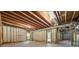 Unfinished basement with exposed beams and window, awaiting customization and finishing at 771 Tate Overlook, Marietta, GA 30064