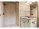 Well-lit bathroom featuring a shower, tiled walls, a single sink vanity, and modern fixtures at 771 Tate Overlook, Marietta, GA 30064