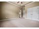 Large bedroom featuring neutral carpeting, a ceiling fan, and multiple entry points at 771 Tate Overlook, Marietta, GA 30064
