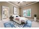 Bright bedroom with stylish blue rug, ceiling fan, and an attached bathroom at 771 Tate Overlook, Marietta, GA 30064