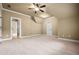 Large bonus room featuring neutral carpeting, a ceiling fan, and multiple entry points at 771 Tate Overlook, Marietta, GA 30064