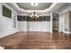 Spacious dining room with dark hardwood floors, white columns, and modern lighting fixtures at 771 Tate Overlook, Marietta, GA 30064