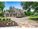 Beautiful brick home with a three-car garage, manicured landscaping, and a circular driveway at 771 Tate Overlook, Marietta, GA 30064
