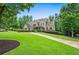A charming brick home with a lush green lawn and well-maintained landscaping, exudes classic elegance at 771 Tate Overlook, Marietta, GA 30064