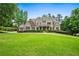 Stately brick home with a sprawling green lawn and mature trees, offering curb appeal and privacy at 771 Tate Overlook, Marietta, GA 30064