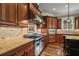 Gourmet kitchen with stainless steel range, custom cabinetry, and granite countertops at 771 Tate Overlook, Marietta, GA 30064
