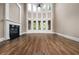 Bright living room with a fireplace, hardwood floors, and large arched windows at 771 Tate Overlook, Marietta, GA 30064