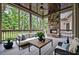 Screened patio with stone fireplace, comfortable seating, and wooded views at 771 Tate Overlook, Marietta, GA 30064