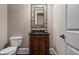 Elegant powder room features a decorative mirror, dark countertop, and stylish vanity at 771 Tate Overlook, Marietta, GA 30064