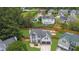 Aerial view of the home showcasing its well-maintained lawn, fenced backyard, and neighborhood setting at 1701 English Ivey Nw Ln, Kennesaw, GA 30144
