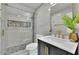 Beautiful bathroom with glass shower, neutral tile and modern gold fixtures at 1701 English Ivey Nw Ln, Kennesaw, GA 30144