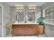 Elegant bathroom features marble tile, double vanity with gold fixtures, and a large plant for added decor at 1701 English Ivey Nw Ln, Kennesaw, GA 30144