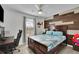 Bedroom with hardwood accent wall, ceiling fan, and neutral decor at 1701 English Ivey Nw Ln, Kennesaw, GA 30144